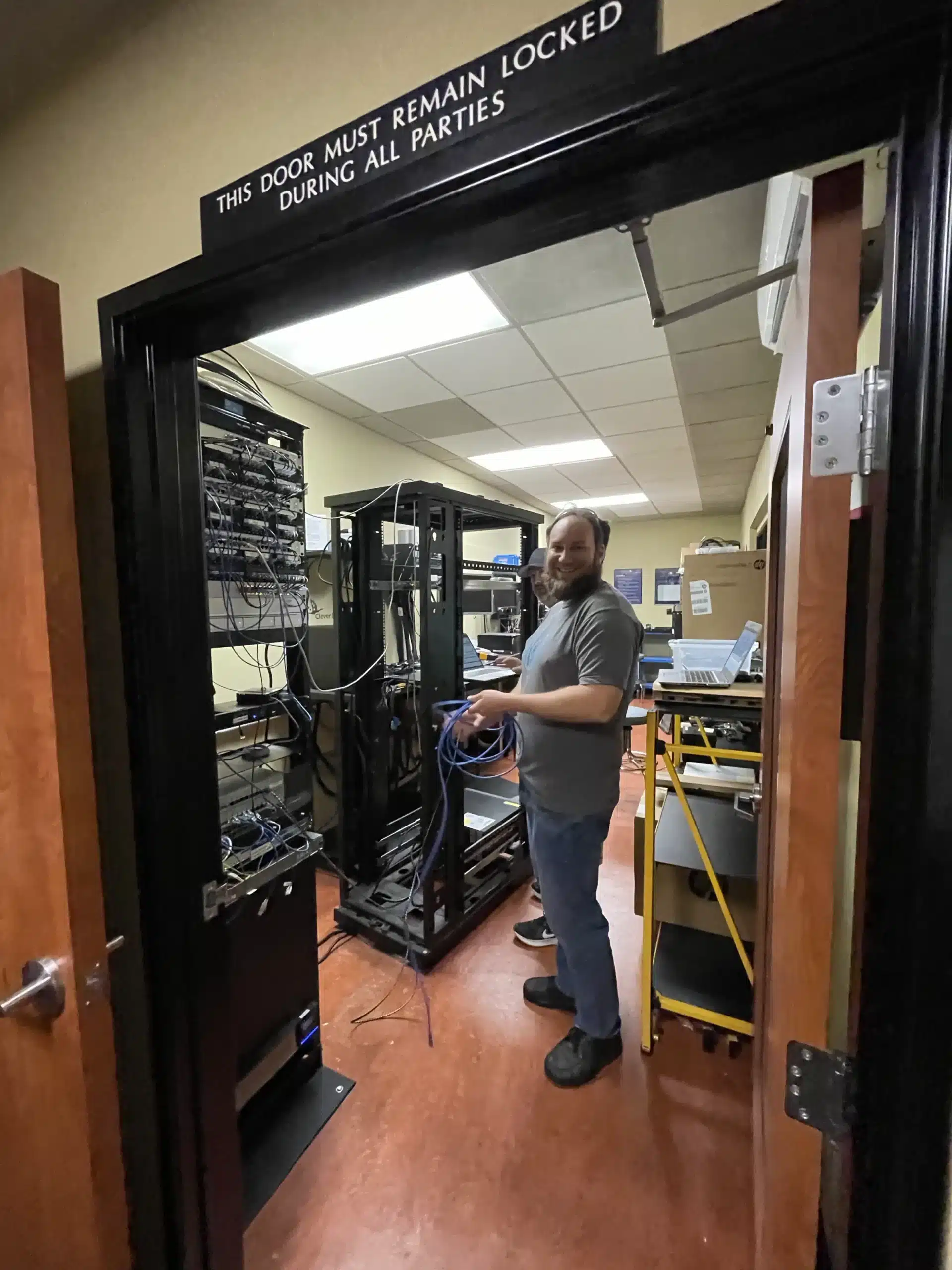 cd-server-room Clever Ducks technician working beside equipment racks in a server room