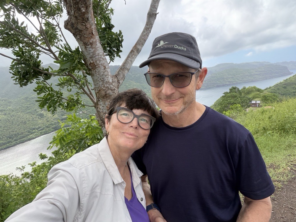 Peter and Amy Kardel standing together while being on a hike